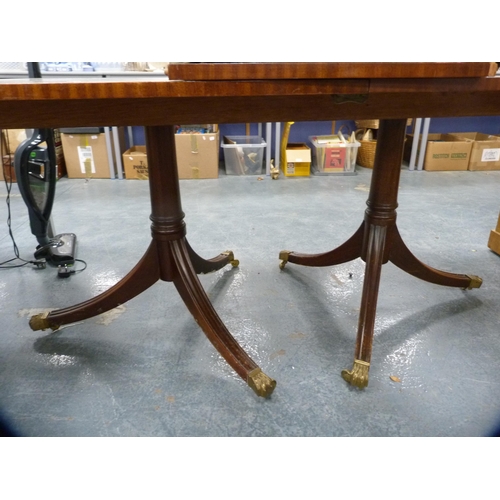 393 - Reproduction twin-pedestal dining table with two additional leaves, on brass paw feet and cappings, ... 