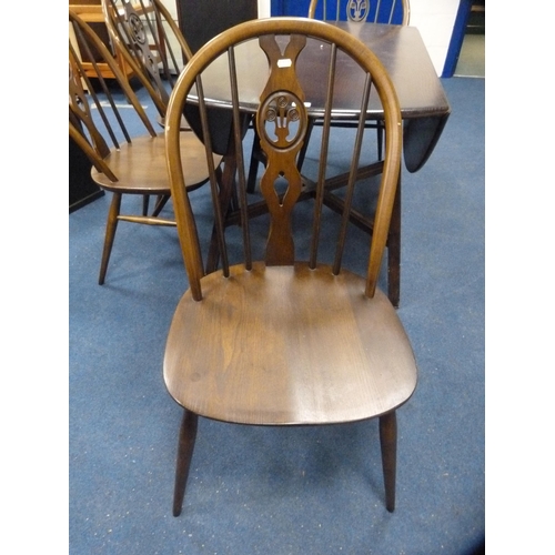 406 - Ercol drop-leaf dining table and a set of four wheel-back spindle chairs.  (5)