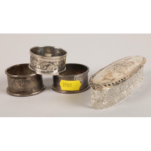 205 - Silver topped dressing table jar and three napkin rings (4)