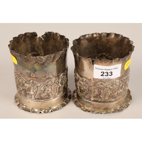 233 - Pair silver beakers decorated with cherubs.weight 200 grams