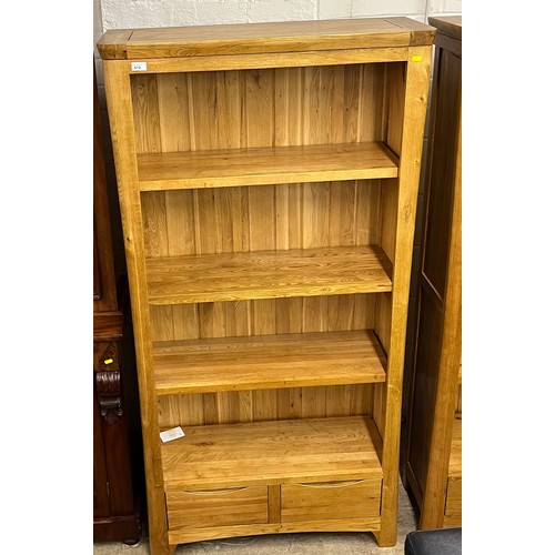 612 - Contemporary oak bookcase over two fitted drawers