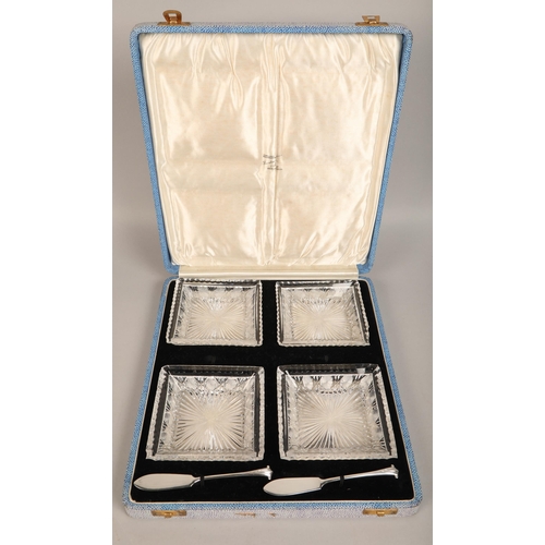 351 - Cased set of four cut glass serving dishes and two silver buttter knives