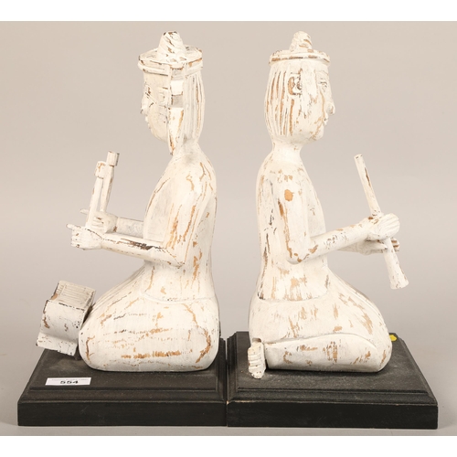 554 - Pair of contemporary Tibetan book ends, 36 cm high (2)