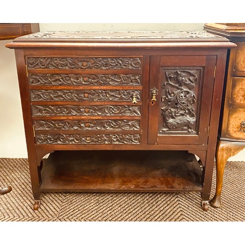 561 - Chinese carved hardwood cupboard75 37 71 on coasters, top and doors carved with dragons, 76 x 37 x 7... 