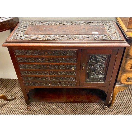 561 - Chinese carved hardwood cupboard75 37 71 on coasters, top and doors carved with dragons, 76 x 37 x 7... 