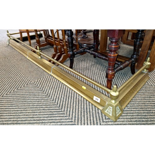 579 - Brass fender and brass companion stand 144 cm long