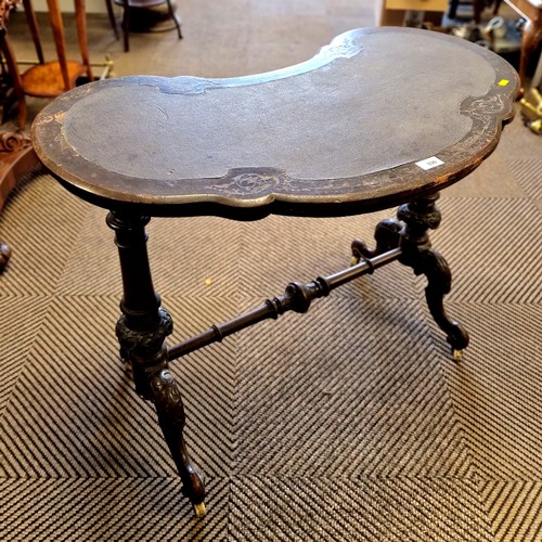 590 - Kidney shaped hall table on elaborate carved legs with ceramic castors and leather top 36 x 86 x 69 ... 