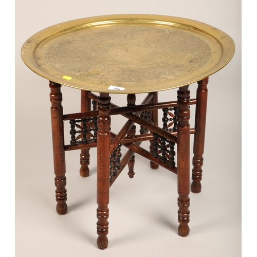 509 - Brass topped Benares folding table,  59 cm diameter