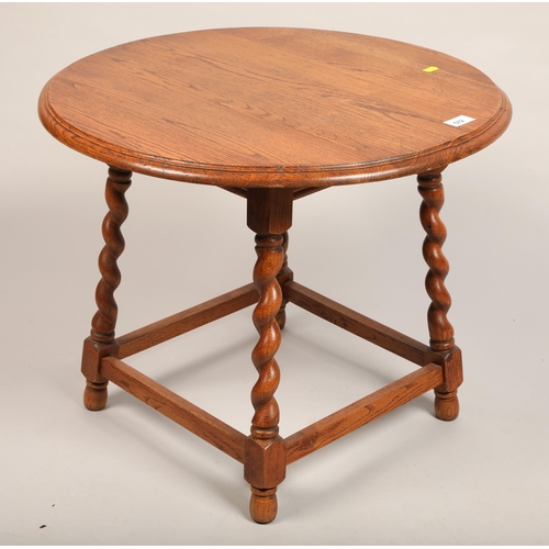 572 - Round oak occasional table with barley twist legs, 50 cm high, 61 cm diameter