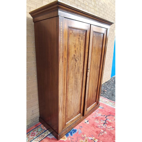 412 - Edwardian inlaid mahogany wardrobe with moulded cornice above two panelled doors on plinth base. app... 