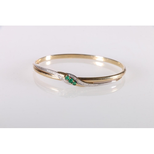 173 - 14ct gold bangle set with three Columbian emeralds and diamond chips, clasp stamped '585', 6.8g gros... 