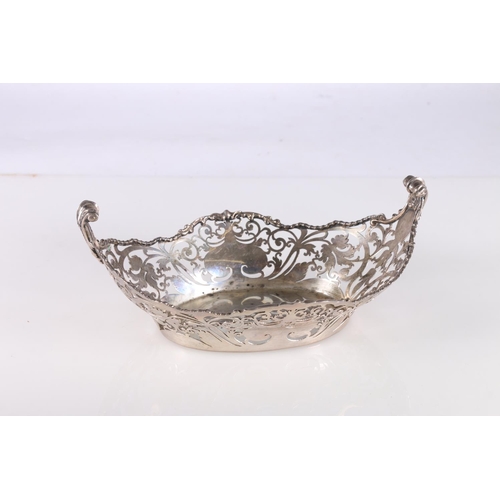 31 - George V silver dish of oval form with pierced sides and two scroll handles, by Josiah Williams &... 