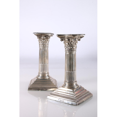 36 - Pair of silver dwarf candlesticks with Corinthian column stems by William Hutton & Sons Ltd, Lon... 