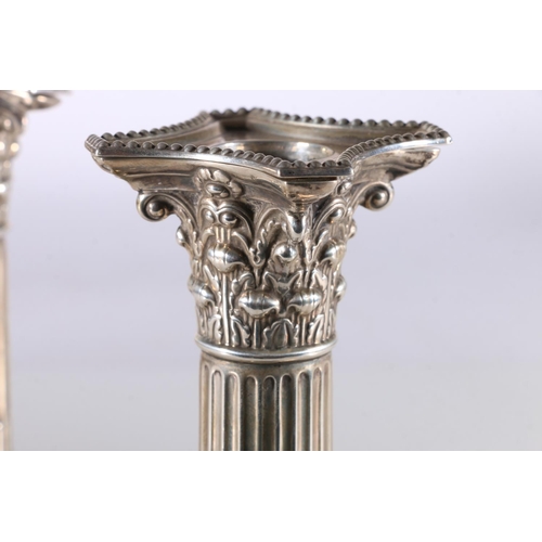 36 - Pair of silver dwarf candlesticks with Corinthian column stems by William Hutton & Sons Ltd, Lon... 