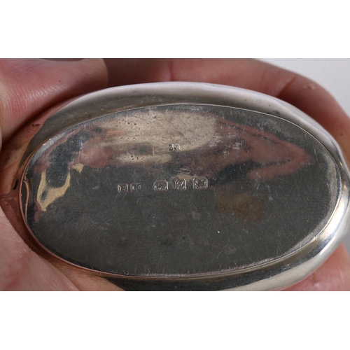 63 - Victorian antique silver snuff box of oval shape, the lid decorated in repousse with scene of a gent... 