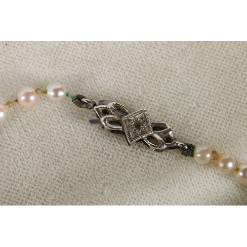 196 - Single strand graduated pearl necklace with 9ct white gold closure set with small diamond, 57cm long... 