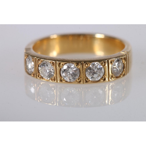 200 - Unhallmarked yellow metal dress ring set with five 0.2ct diamonds, ring size L/M, 5.4g gross.