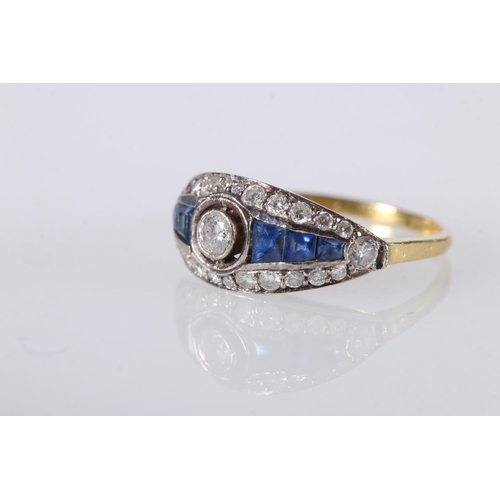 204 - 18ct gold sapphire and diamond dress ring, the central 0.125ct collet set diamond surrounds by gradu... 