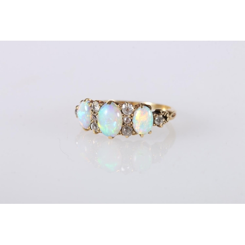 214 - Unhallmarked yellow metal gem set ring, the three oval opals surrounded by eight diamond, ring size ... 