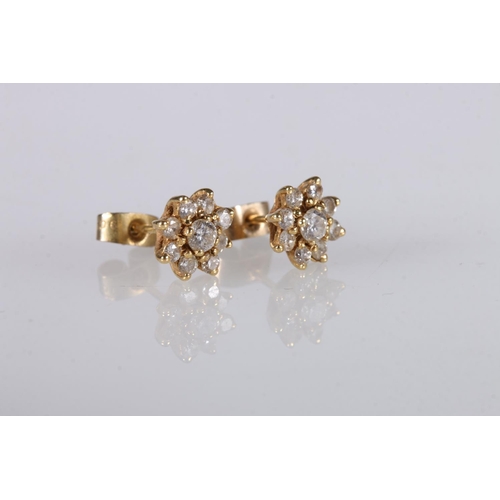 216 - Pair of yellow gold ear studs set with diamond in a flower head form, marks rubbed, 2g gross. 