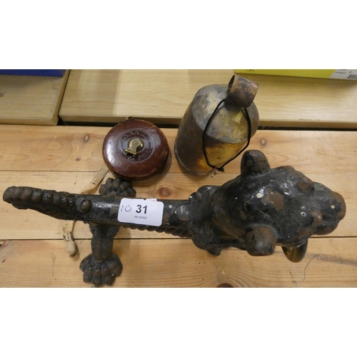 31 - Large cast iron fire dog, a bell also a tape measure.