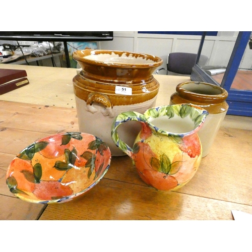 51 - Two large stoneware storage jars and a floral jug and bowl.