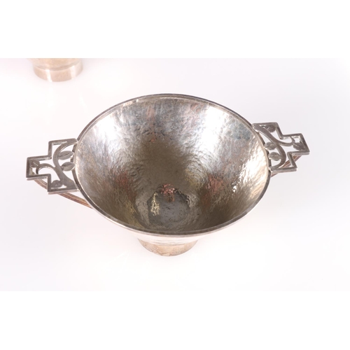 91 - Arts & Craft hammered white metal sugar bowl and cream jug with pierced floral design handles, u... 