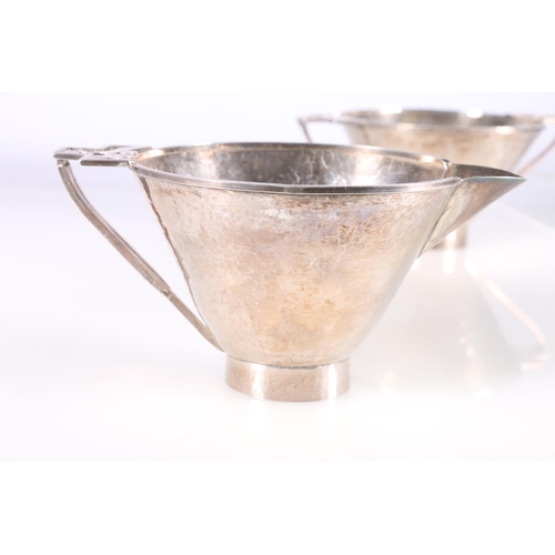 91 - Arts & Craft hammered white metal sugar bowl and cream jug with pierced floral design handles, u... 