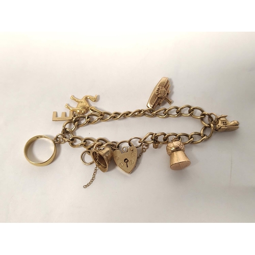 109 - 9ct gold charm bracelet with various charms including a 22ct gold ring (2g approximately) 24g in all... 