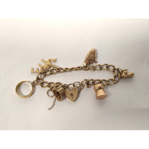 109 - 9ct gold charm bracelet with various charms including a 22ct gold ring (2g approximately) 24g in all... 