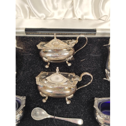 129 - Silver six piece condiment set of Georgian style, cased.