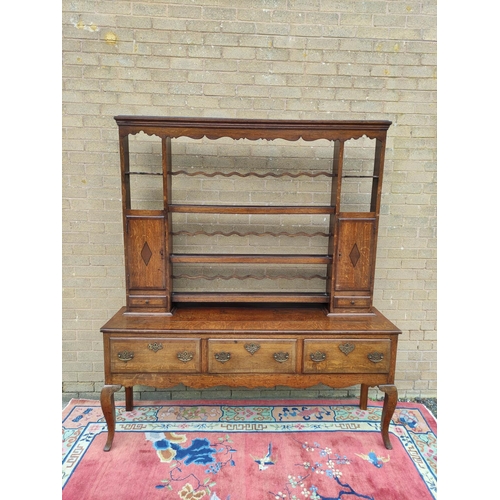 418 - Georgian style oak dresser. upper section with shaped apron above open delft shelving flanked with f... 