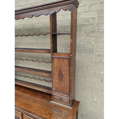 418 - Georgian style oak dresser. upper section with shaped apron above open delft shelving flanked with f... 