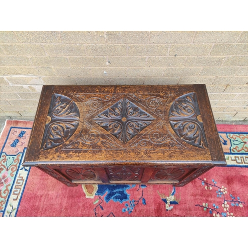 419 - Antique oak coffer with hinged top, decorated with carved lozenge decoration. 69cm high, 92cm wide, ... 