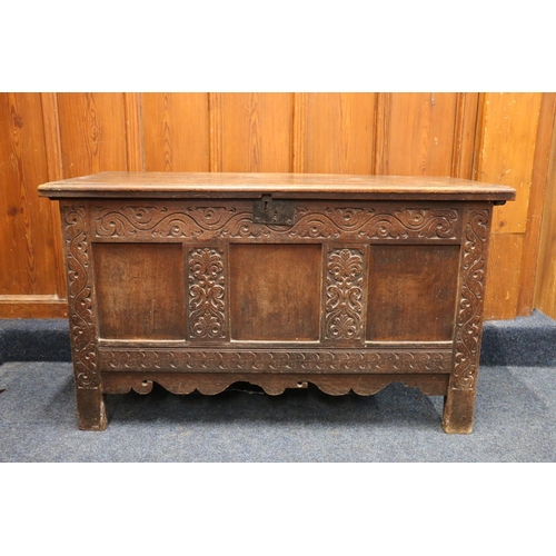 512 - Antique oak blanket box, the hinged top opening to reveal interior with candle box, the front with f... 