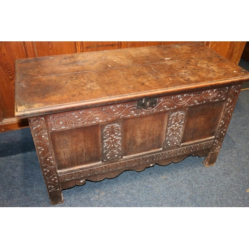 512 - Antique oak blanket box, the hinged top opening to reveal interior with candle box, the front with f... 