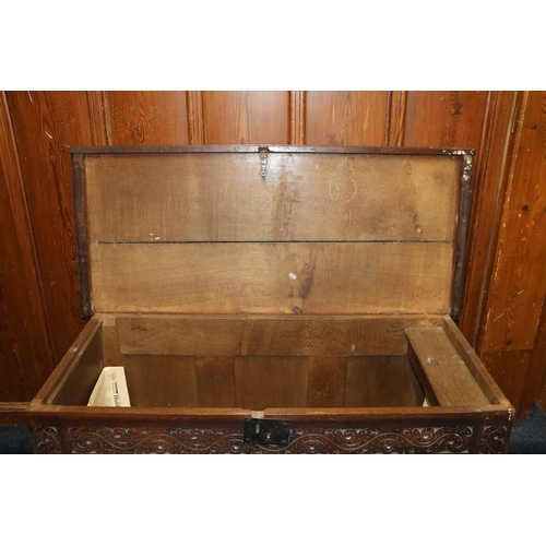 512 - Antique oak blanket box, the hinged top opening to reveal interior with candle box, the front with f... 