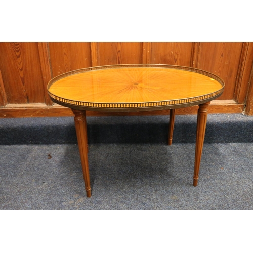 515 - French Empire style oval coffee table with pierced metal gallery, raised on circular tapering fluted... 