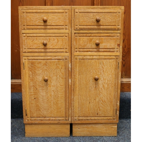 517 - Heals of London, a limed oak cabinet (made up) having four short drawers above two cupboard doors, r... 