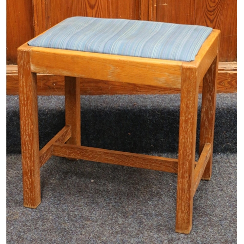 521 - Manner of Heals of London, a limed oak framed dressing table stool, 43cm wide.