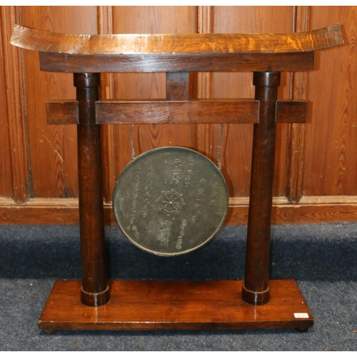 526 - Chinese gong, the oak frame of temple form supporting a circular bronze gong with character mark and... 