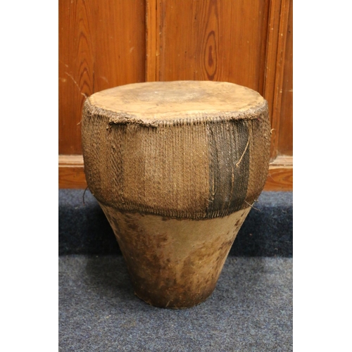 528 - African skin and hide covered drum, 49cm tall, 42cm diameter.