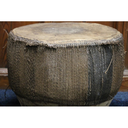 528 - African skin and hide covered drum, 49cm tall, 42cm diameter.