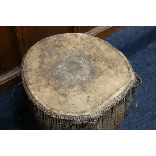 528 - African skin and hide covered drum, 49cm tall, 42cm diameter.