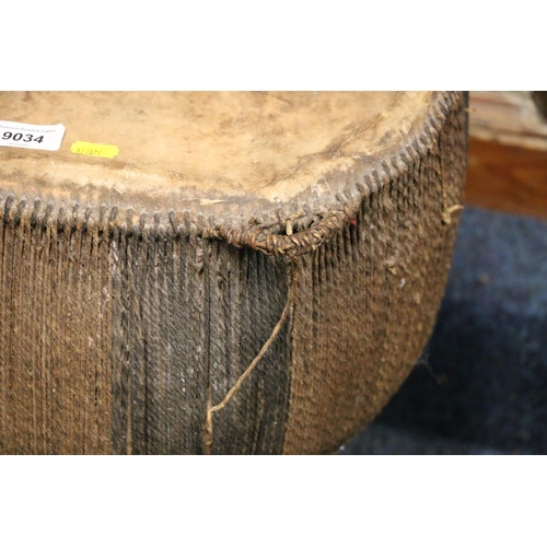 528 - African skin and hide covered drum, 49cm tall, 42cm diameter.