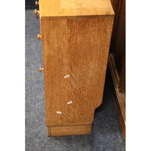 517 - Heals of London, a limed oak cabinet (made up) having four short drawers above two cupboard doors, r... 