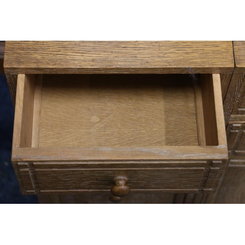 517 - Heals of London, a limed oak cabinet (made up) having four short drawers above two cupboard doors, r... 