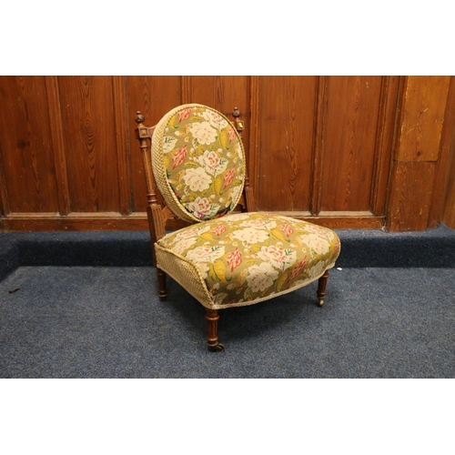 525 - Victorian walnut framed nursing chair, upholstered in green floral patterned needlework covering, ra... 