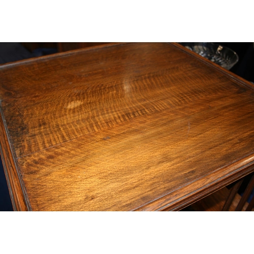 501 - Antique oak revolving bookcase of square section with three tiers of shelves, 115cm tall.