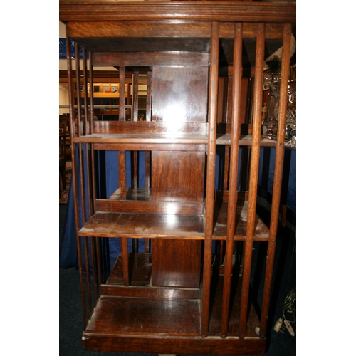 501 - Antique oak revolving bookcase of square section with three tiers of shelves, 115cm tall.